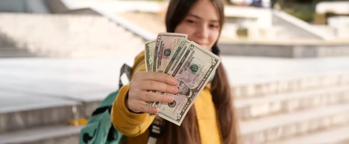 girl holding up money